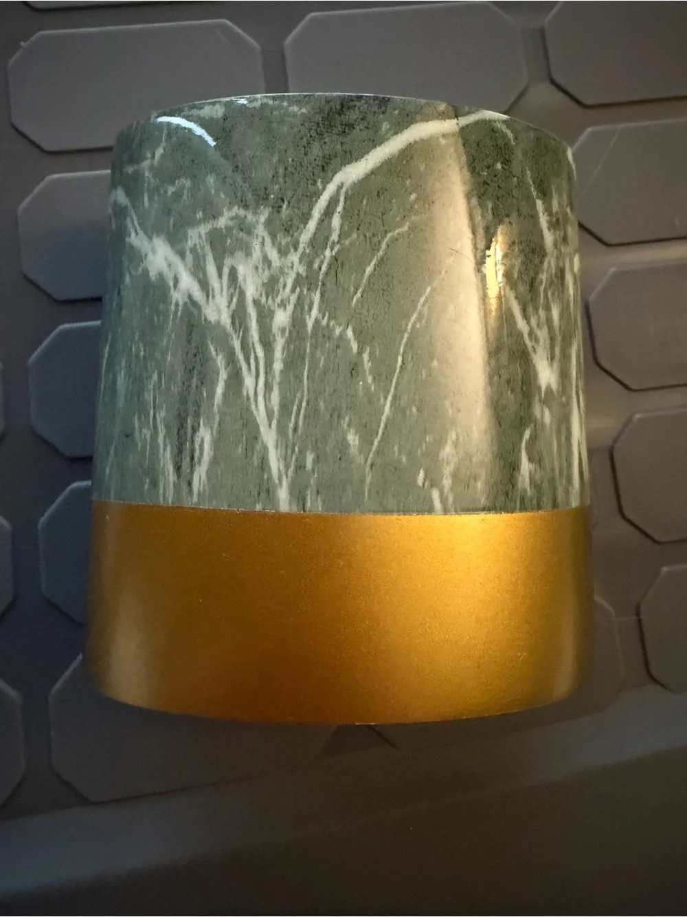 Toothbrush holder green marble pattern with gold colored base.
